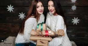 Two smiling female friends in white sweaters holding beautifully wrapped gifts against a dark wooden background with snowflakes, representing best wishes for a new job to a friend that will make them smile.