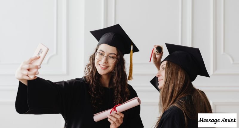 Graduates taking selfie in cap and gown for Instagram caption