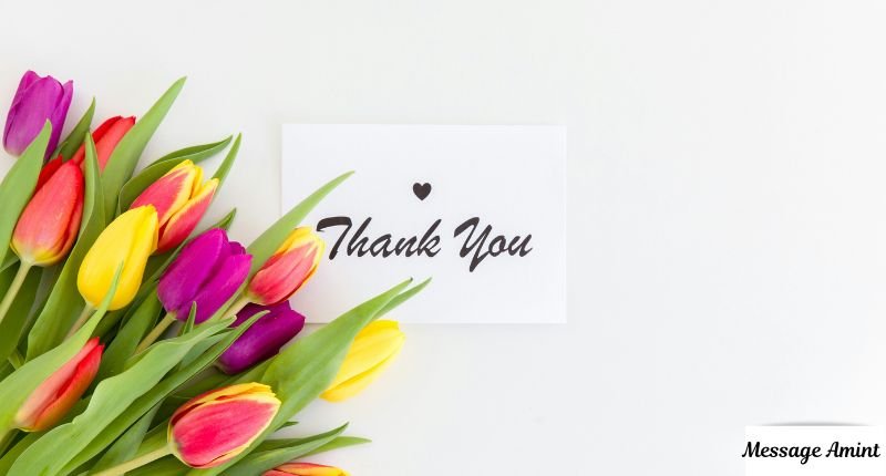 A white thank you card with a small heart next to a bouquet of colorful tulips, perfect for heartfelt thank you messages for a sister-in-law's love and support.